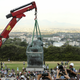 Students cheer as the statue of Cecil John Rhodes is removed from the University of Cape Town (UCT), April 9, 2015. The statue at the university, one of Africa's top academic institutions, has been covered up for the past few weeks as both white and black students regularly marched past with #Rhodesmustfall placards calling for its removal. They believe it is a symbol of the racism against blacks that prevails in South Africa two decades after the end of oppressive white-minority rule.